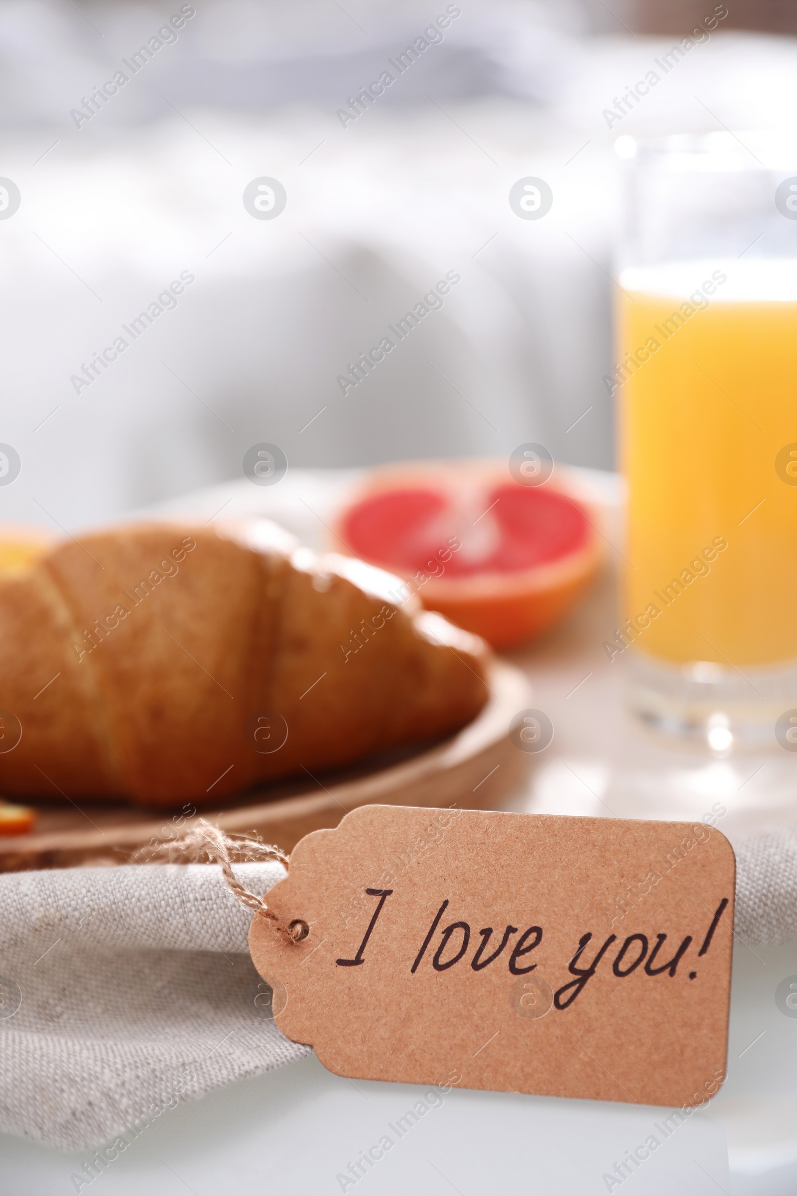 Photo of Romantic breakfast with tag saying I Love You on table