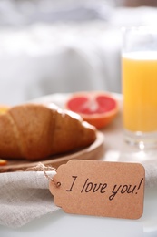 Romantic breakfast with tag saying I Love You on table