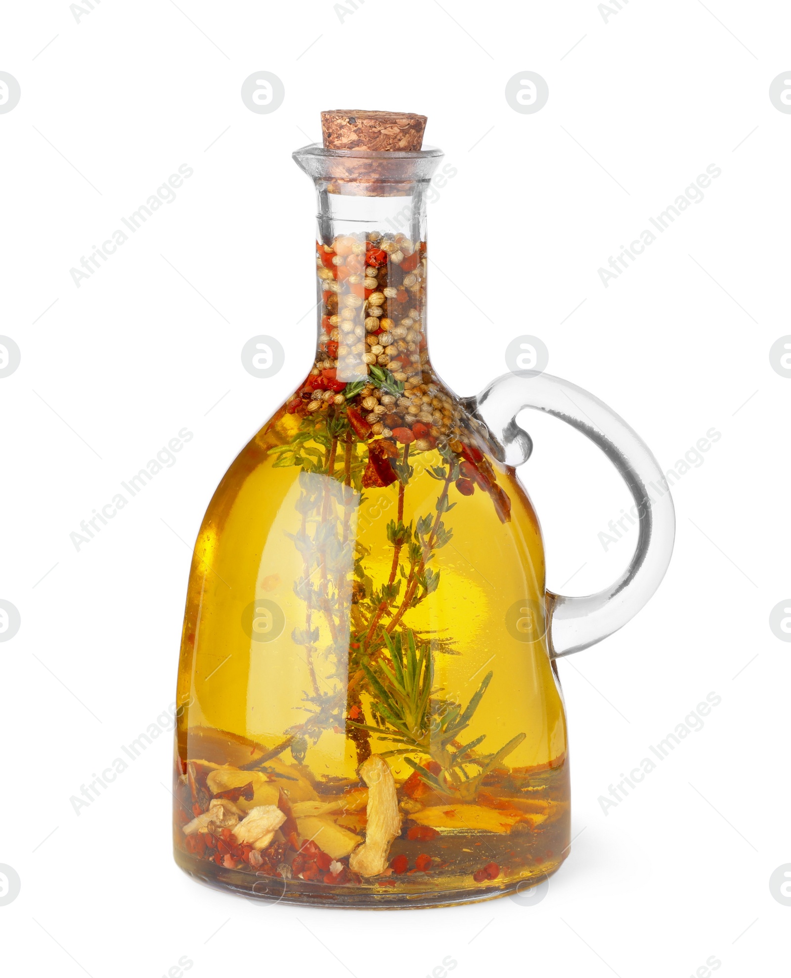 Photo of Glass jug of cooking oil with spices and herbs isolated on white