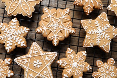 Photo of Tasty Christmas cookies on cooling rack, top view