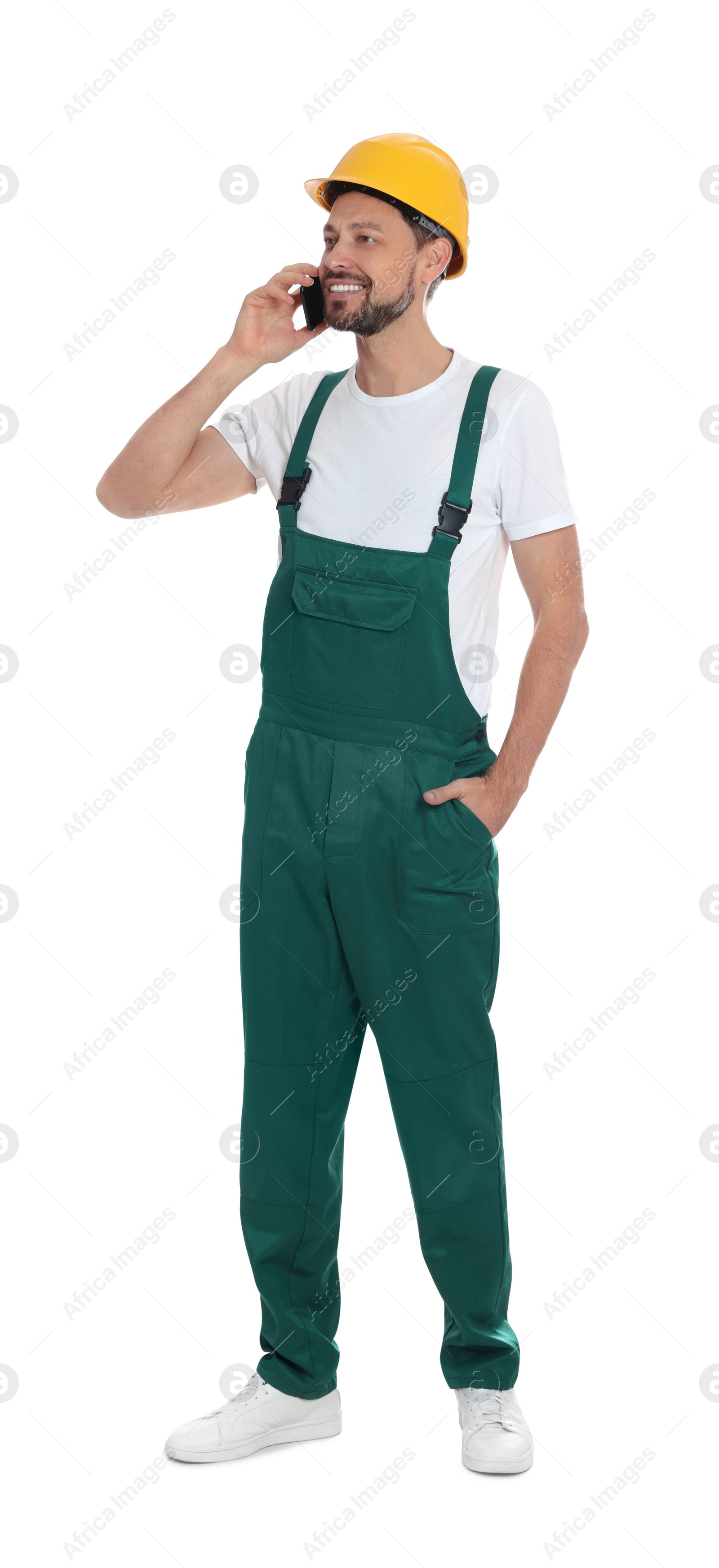 Photo of Professional repairman in uniform talking on phone against white background