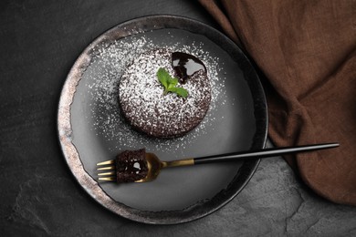 Photo of Delicious fresh fondant with hot chocolate and mint on black table, top view