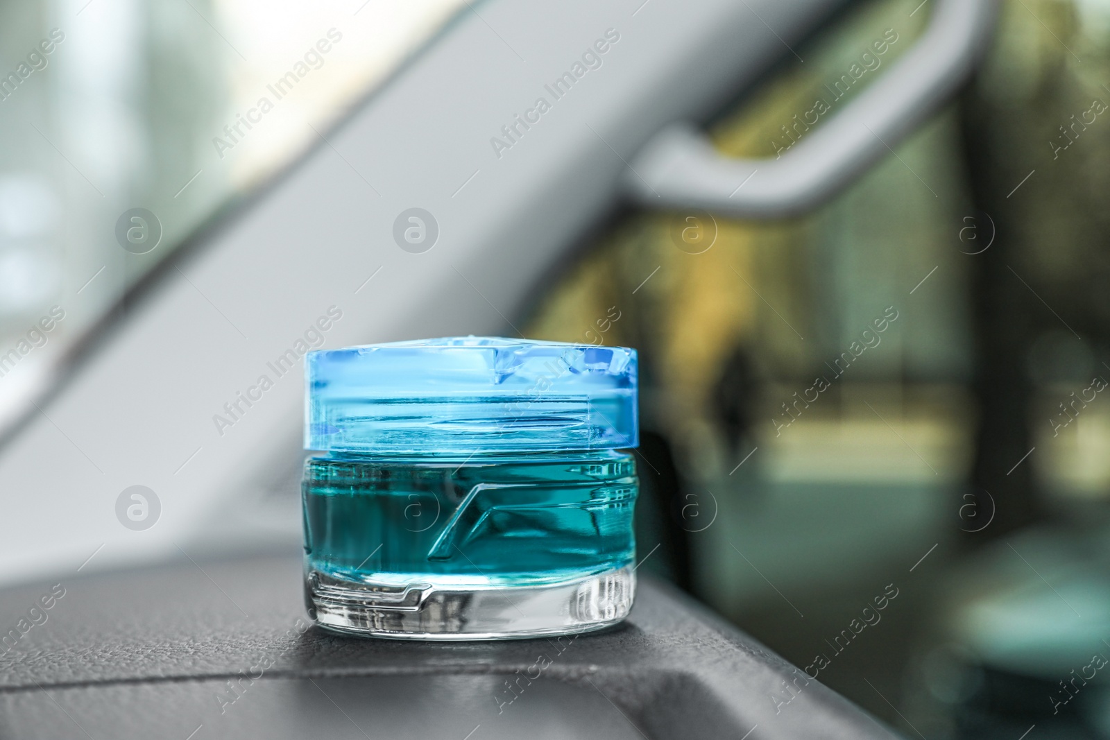 Photo of Stylish air freshener on dashboard in car