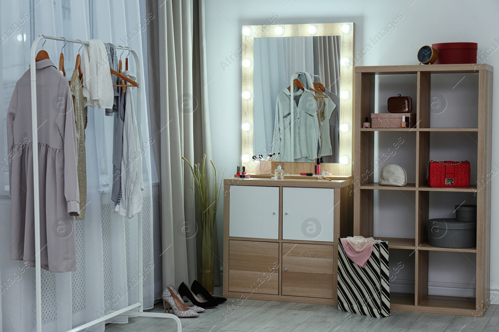 Photo of Dressing room interior with makeup mirror, wardrobe rack and shelving unit