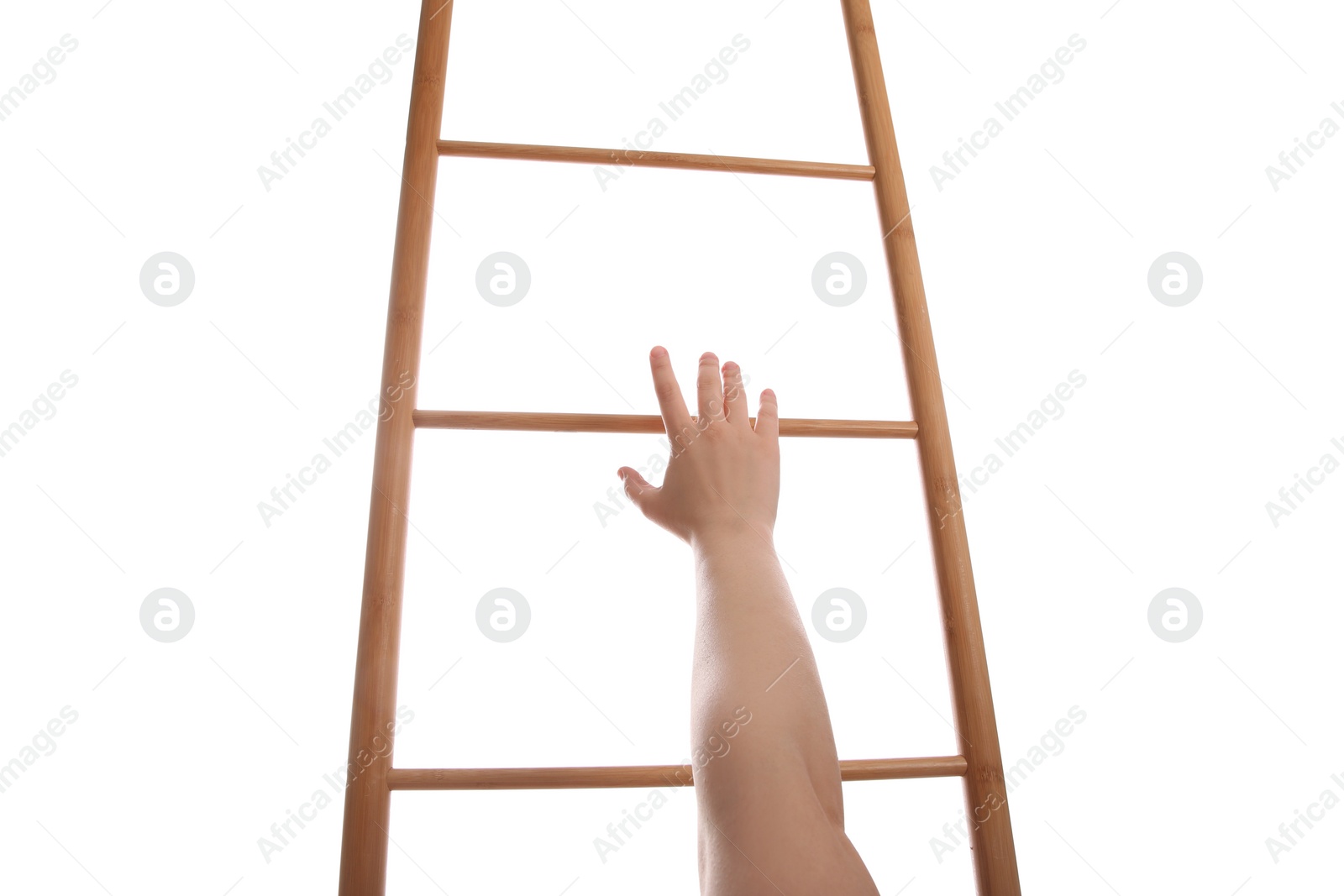 Photo of Woman climbing up wooden ladder against white background, closeup