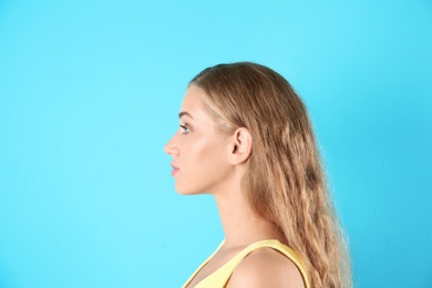 Photo of Young woman on color background. Hearing problem