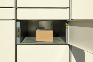 Photo of Open box with package in parcel locker
