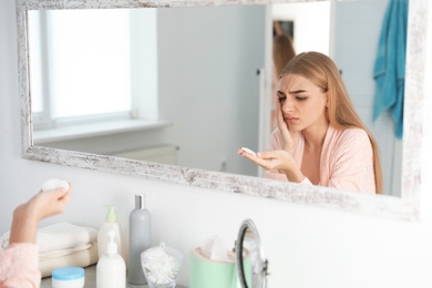 Photo of Young woman with eyelash loss problem indoors