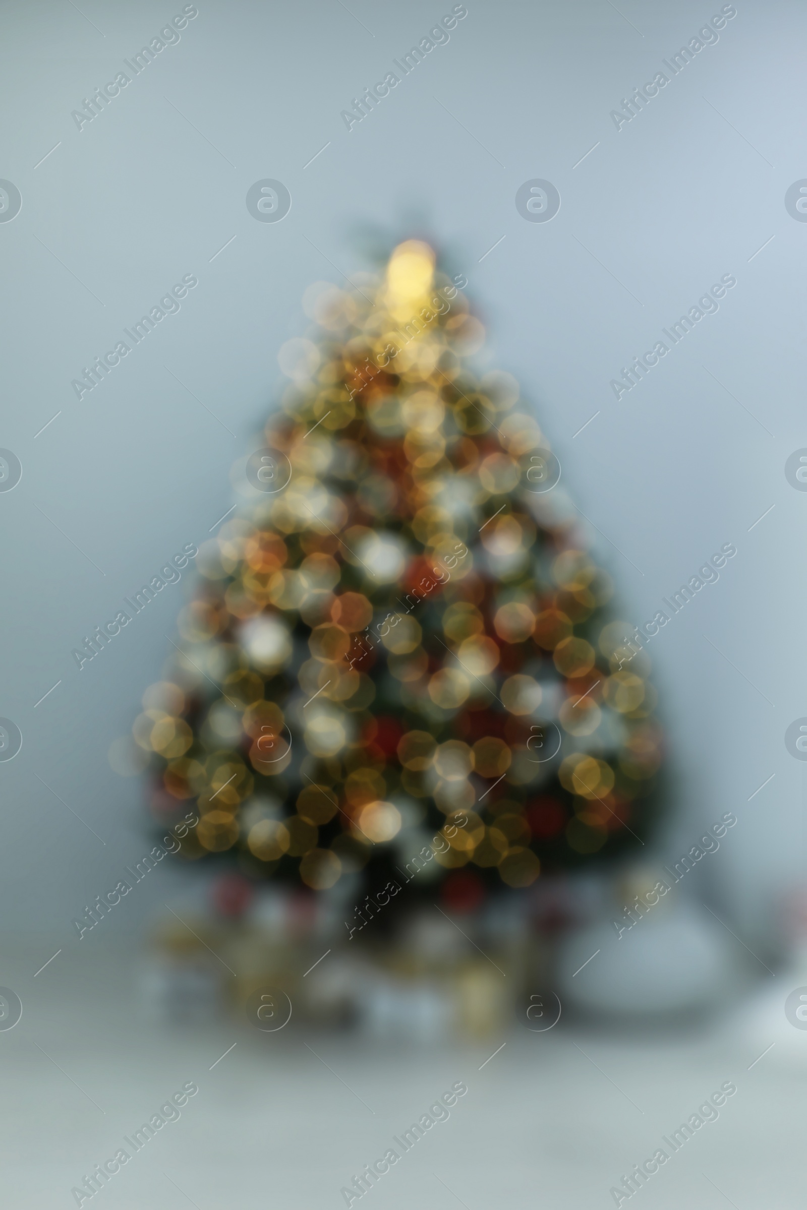 Photo of Blurred view of beautifully decorated Christmas tree in room
