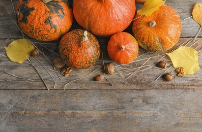 Photo of Orange pumpkins on wooden background, flat lay composition with space for text. Autumn holidays