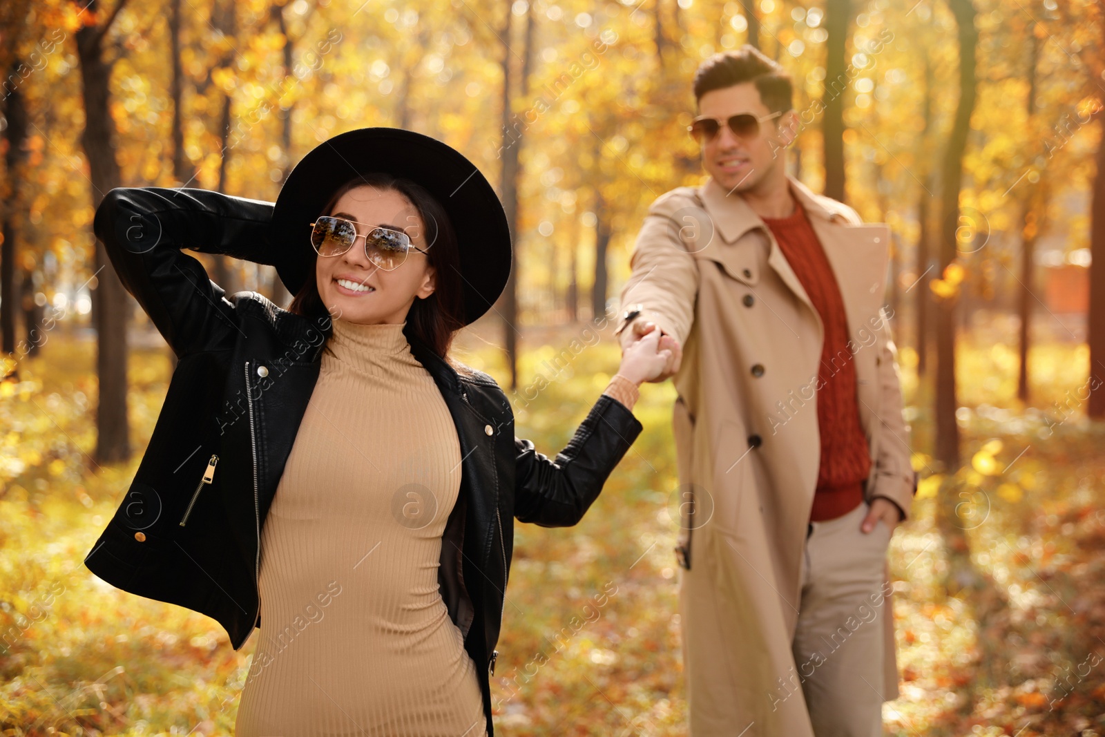 Photo of Lovely couple walking in park on autumn day