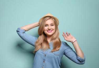 Photo of Attractive young woman in stylish outfit on color background