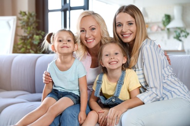 Photo of Little girls with their mother and granny in living room