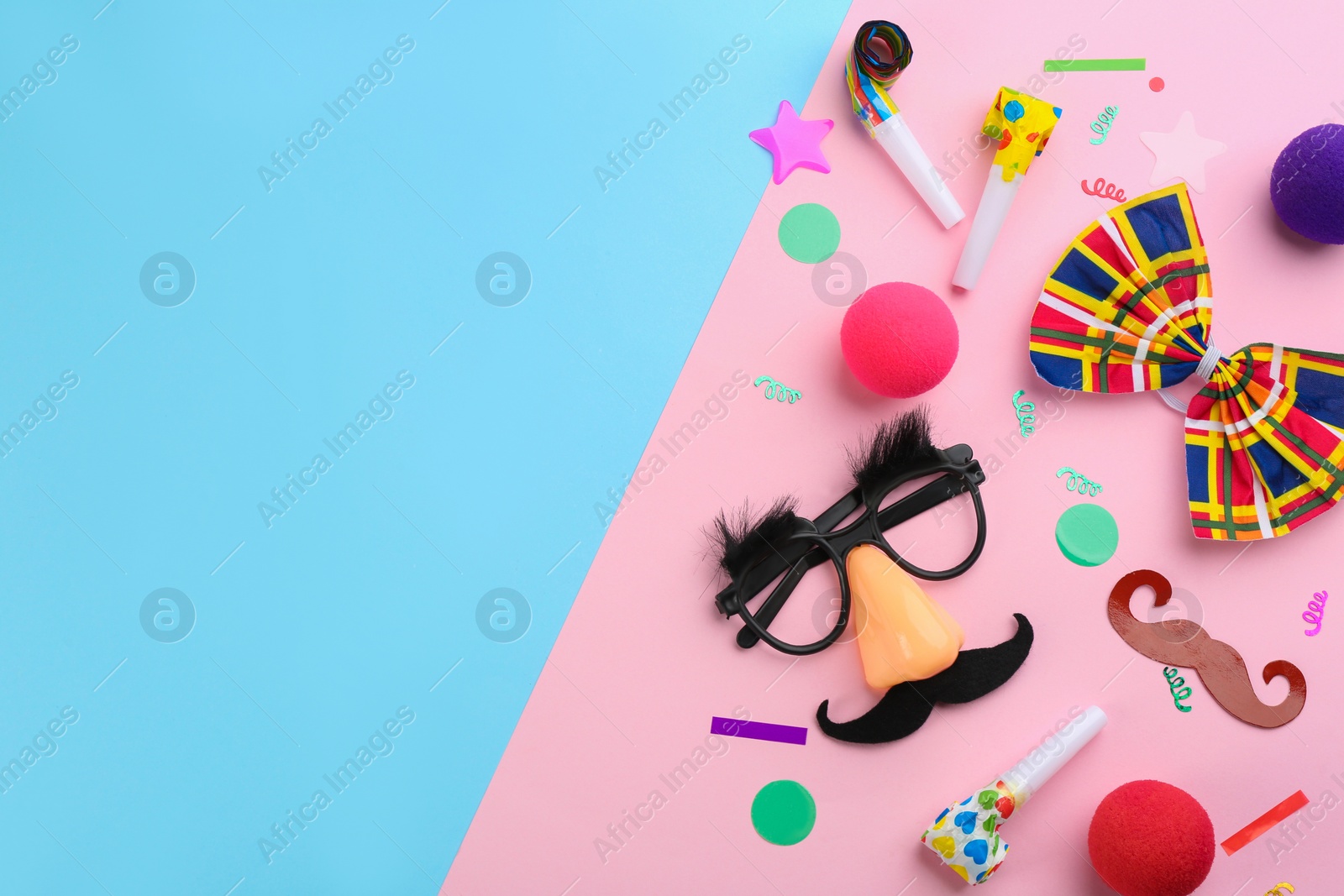 Photo of Flat lay composition with clown's accessories on color background. Space for text