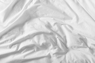 Photo of Crumpled white fabric as background, closeup view