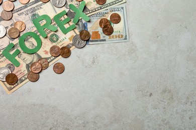 Photo of Word Forex made of green letters with coins and banknotes on light grey table, flat lay. Space for text