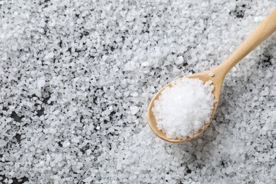 Photo of Natural salt and wooden spoon, top view