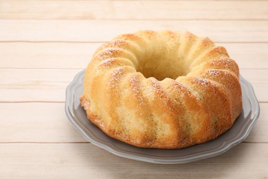 Photo of Delicious freshly baked sponge cake on wooden table, closeup. Space for text