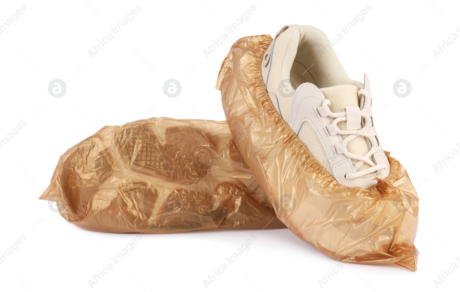 Photo of Sneakers in brown shoe covers isolated on white