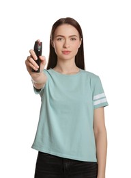 Photo of Young woman using pepper spray on white background