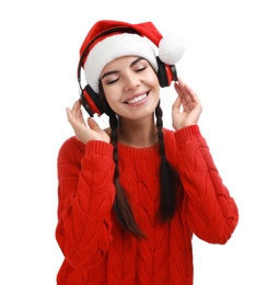 Photo of Young woman in Santa hat listening to Christmas music on white background