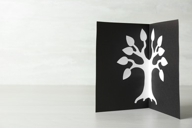 Photo of Card with family tree template on light wooden table. Space for text