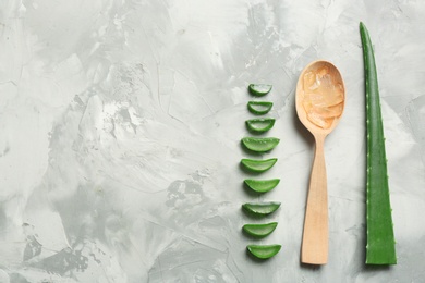 Photo of Flat lay composition with aloe vera leaves and space for text on gray background