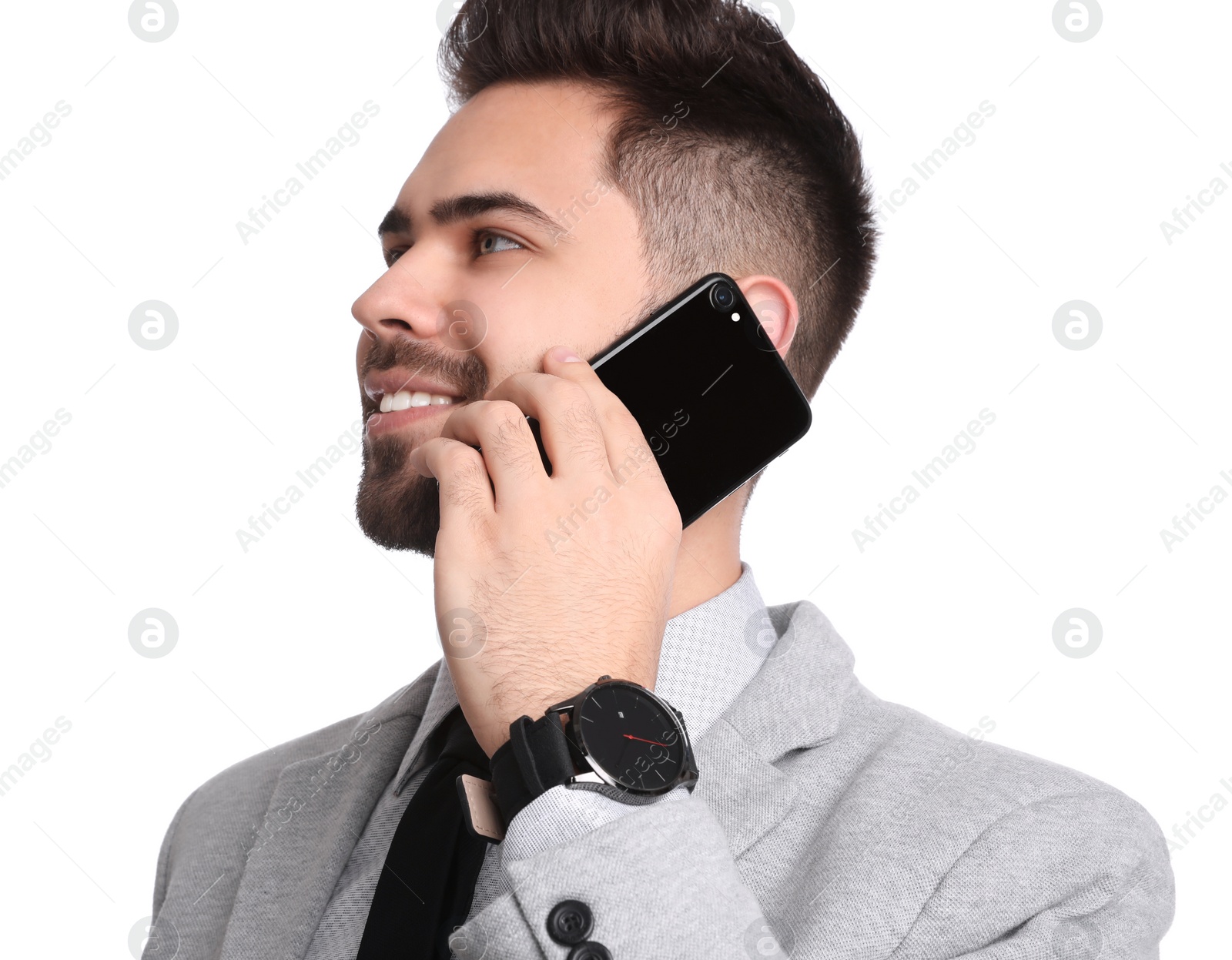 Photo of Young businessman talking on smartphone against white background