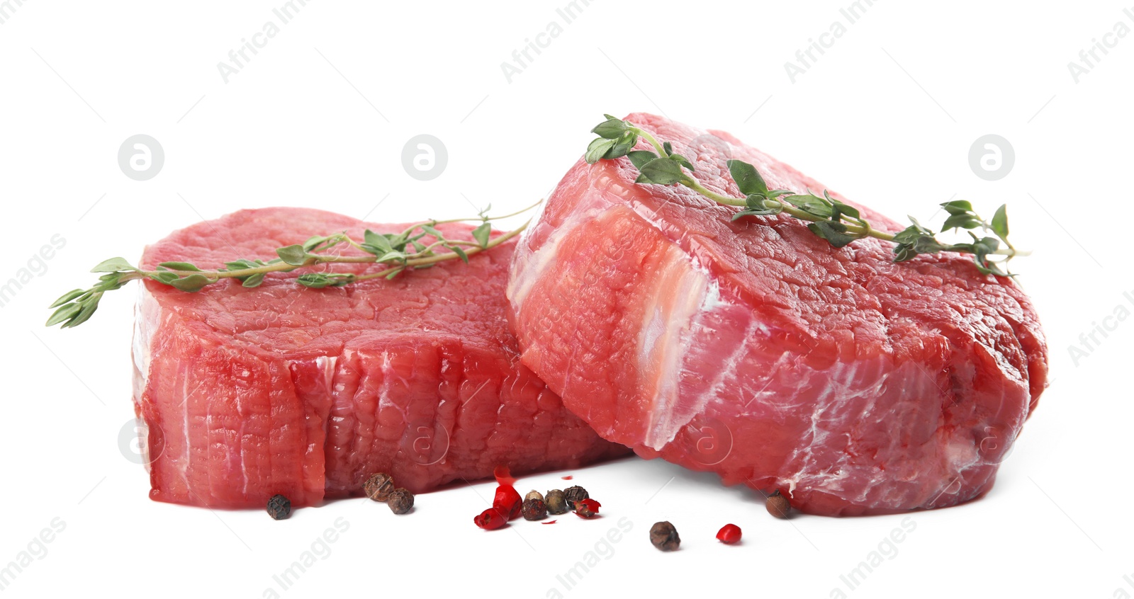 Photo of Fresh raw beef cut with thyme and peppers mix isolated on white