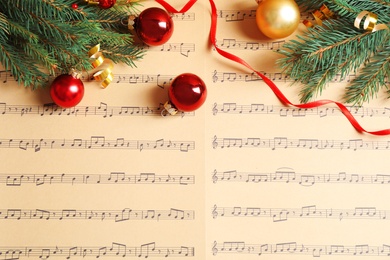 Photo of Flat lay composition with Christmas decorations on music sheets