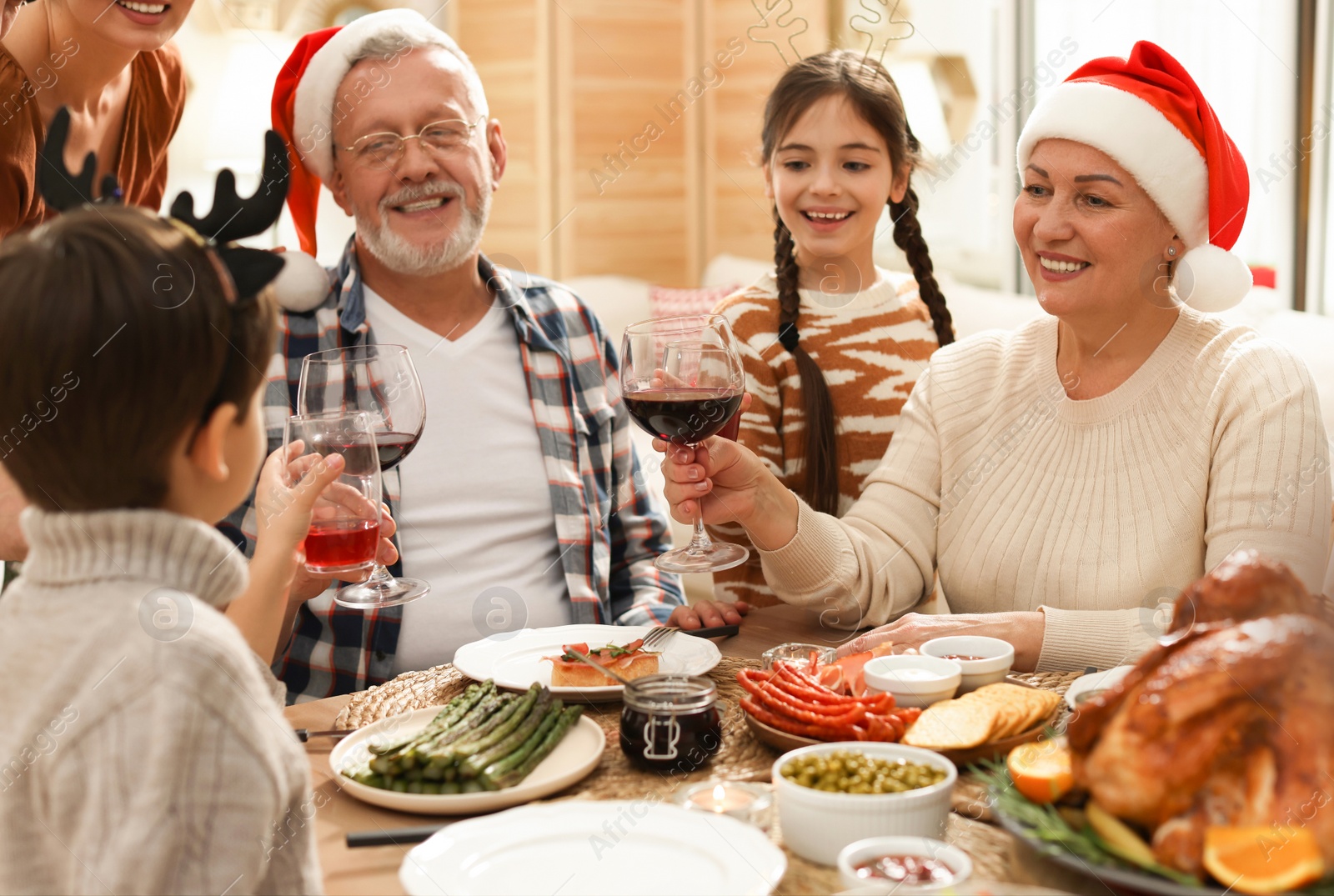 Photo of Happy family enjoying festive dinner at home. Christmas celebration