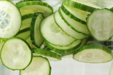 Photo of Large jar of fresh cucumber water, closeup