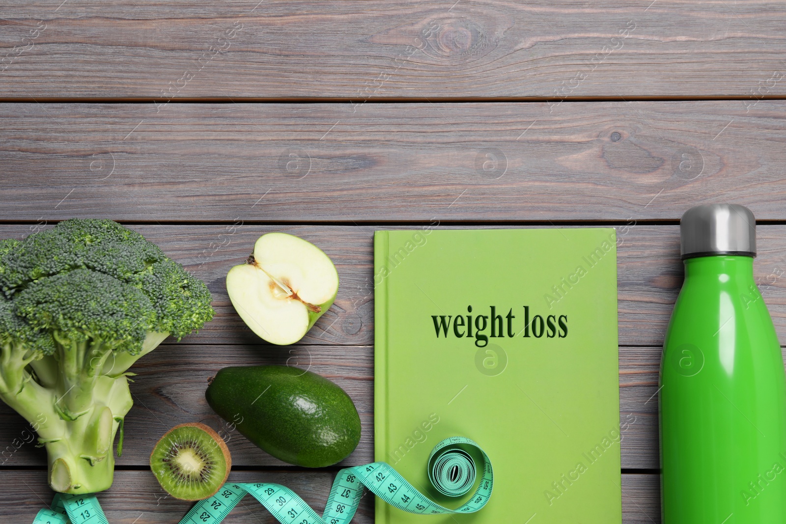 Photo of Weight loss concept. Flat lay composition with notebook, measuring tape and products on grey wooden table, space for text