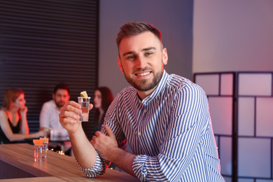 Photo of Young man with Mexican Tequila shot at bar