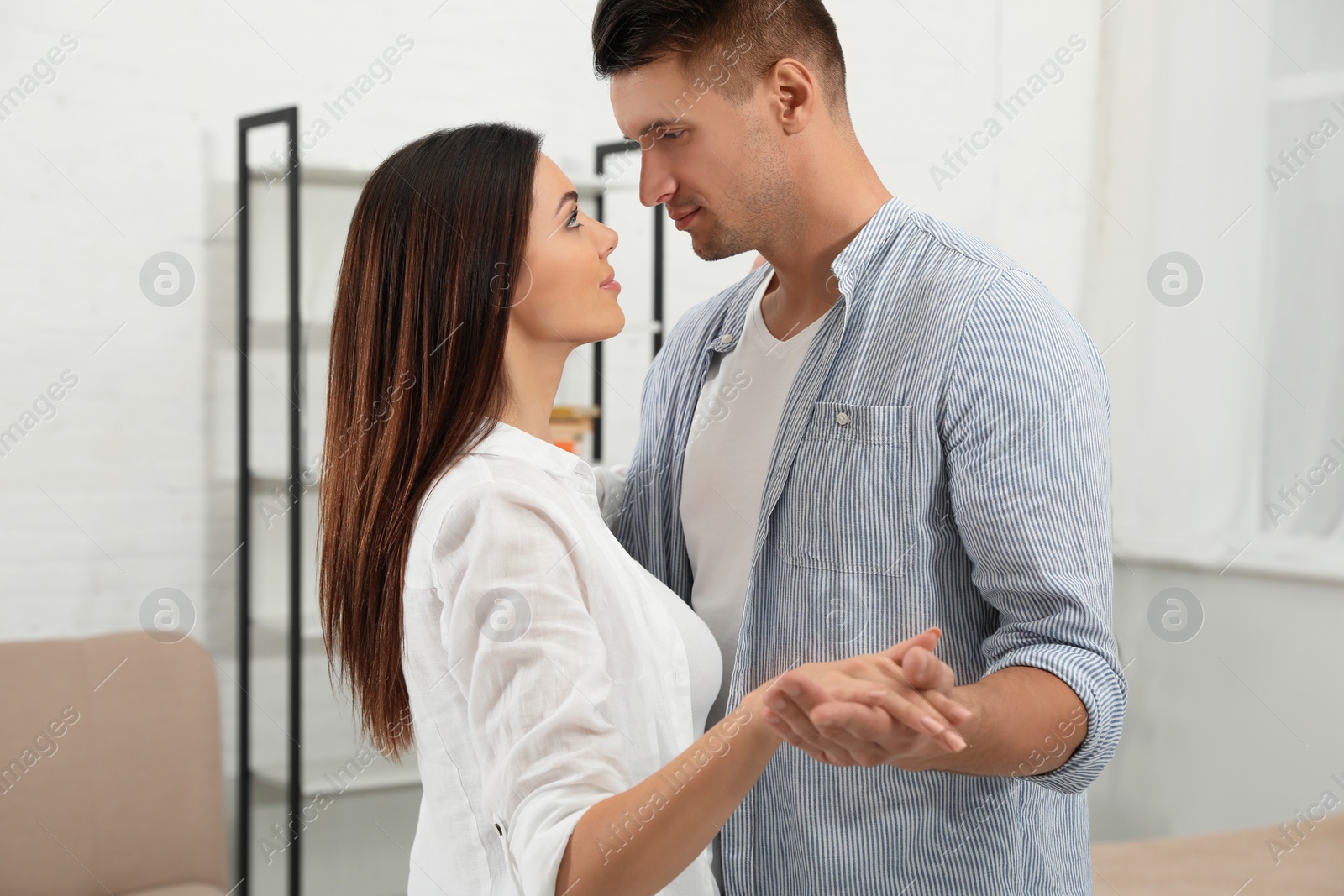 Photo of Happy couple dancing in living room at home