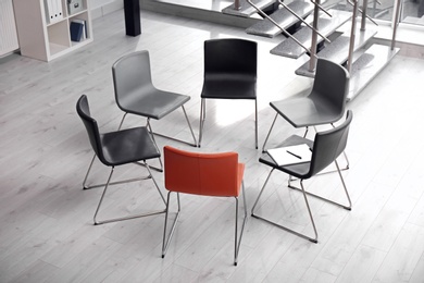 Photo of Chairs prepared for group therapy session in office. Meeting room interior