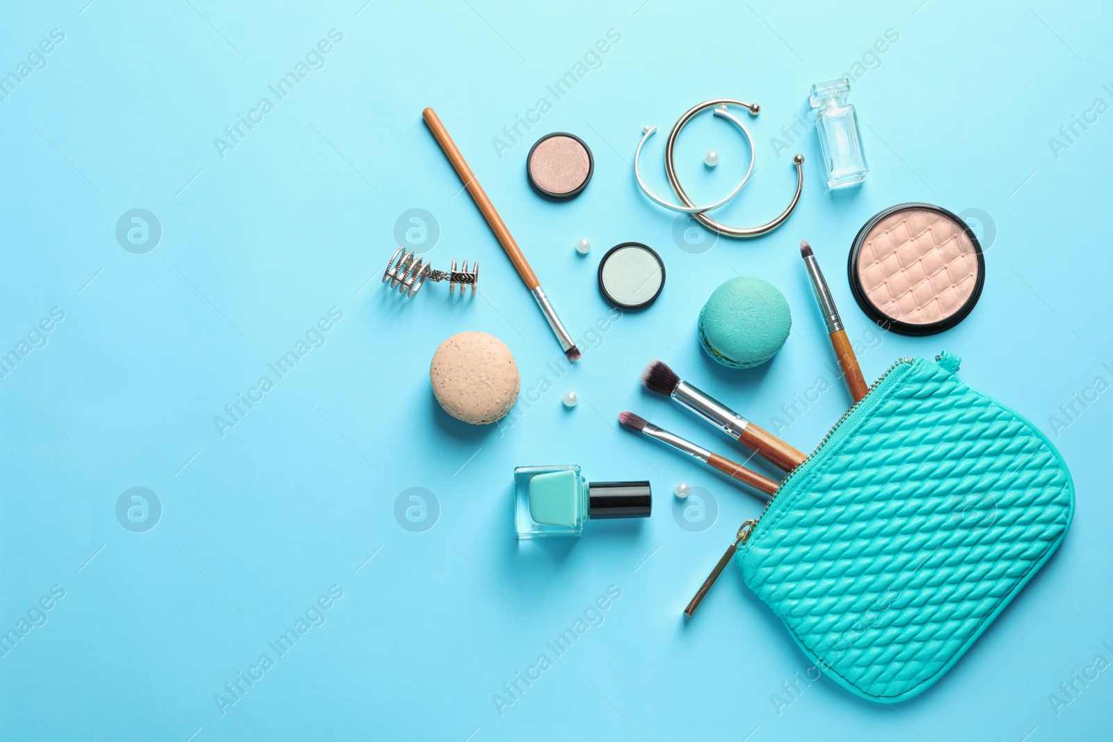 Photo of Makeup products with cosmetic bag on color background