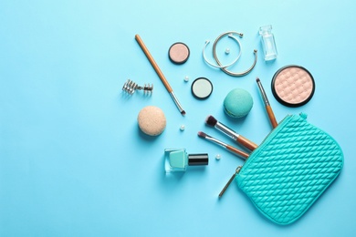 Photo of Makeup products with cosmetic bag on color background