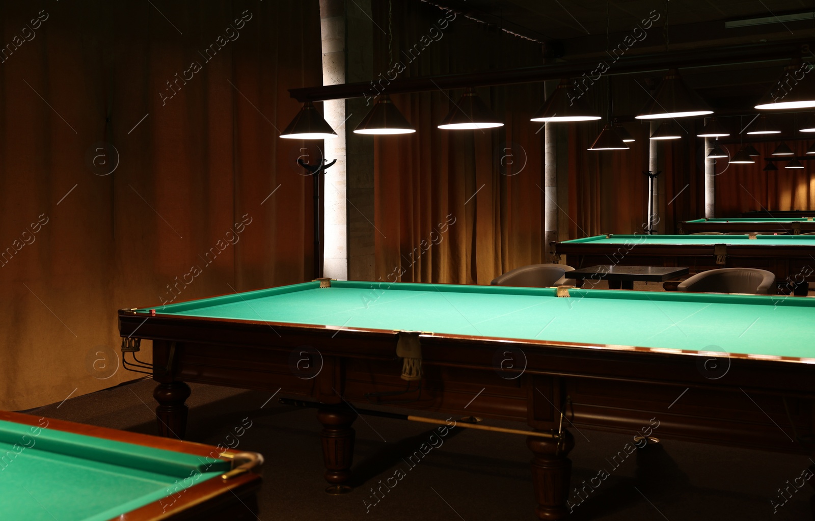 Photo of Empty green billiard tables in club. Pool Game