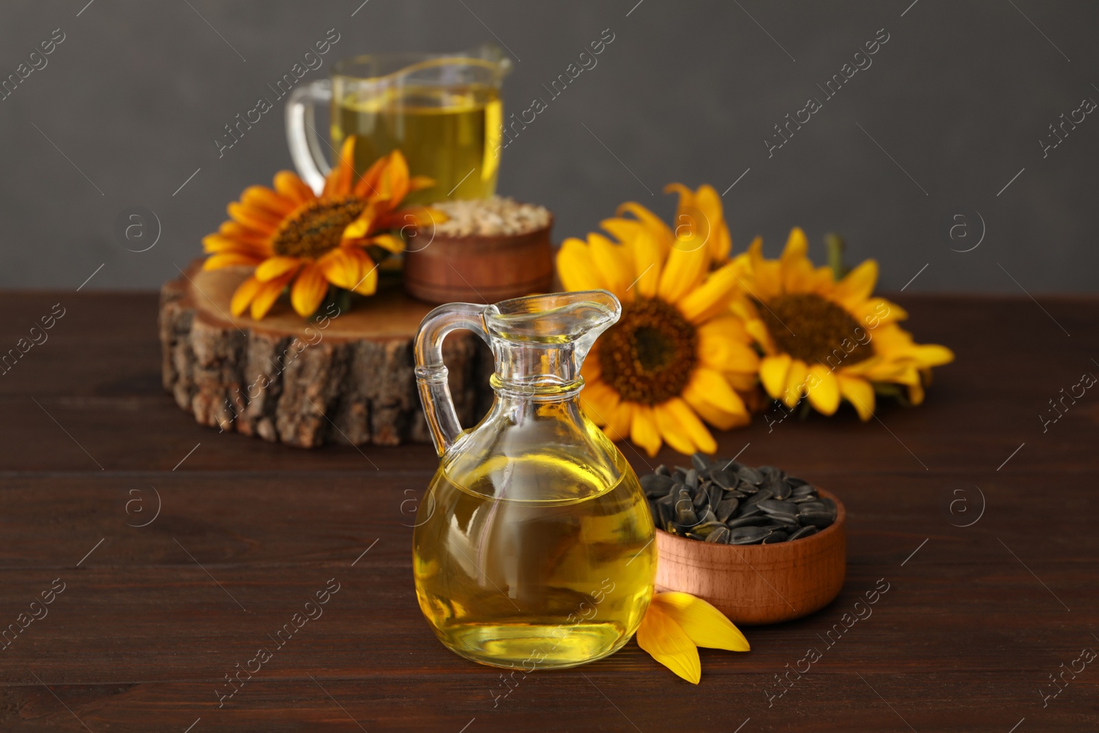 Photo of Sunflower oil and seeds on wooden table