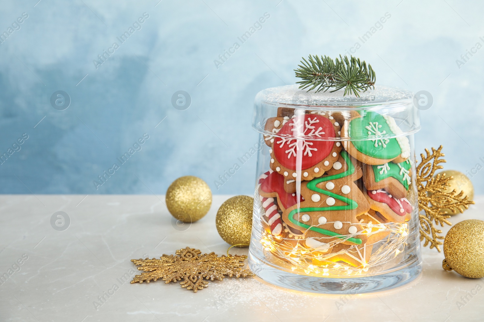 Photo of Glass jar with tasty homemade Christmas cookies on table