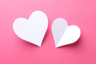 Photo of White paper hearts on pink background, flat lay