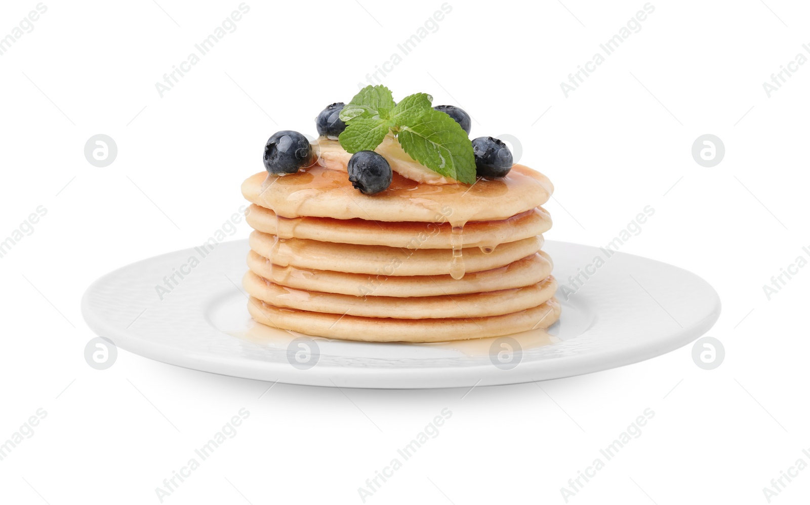 Photo of Delicious pancakes with banana slices, blueberries and mint isolated on white