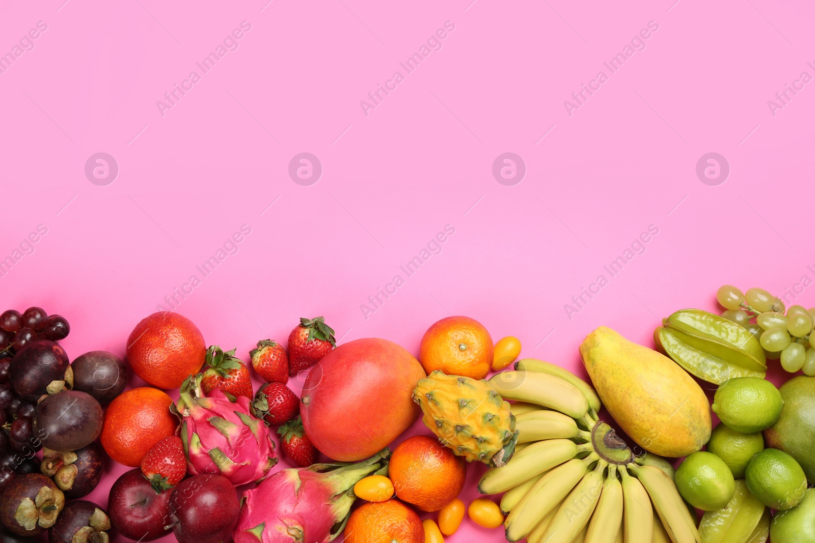 Photo of Many different delicious exotic fruits on pink background, flat lay. Space for text