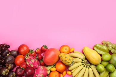 Photo of Many different delicious exotic fruits on pink background, flat lay. Space for text