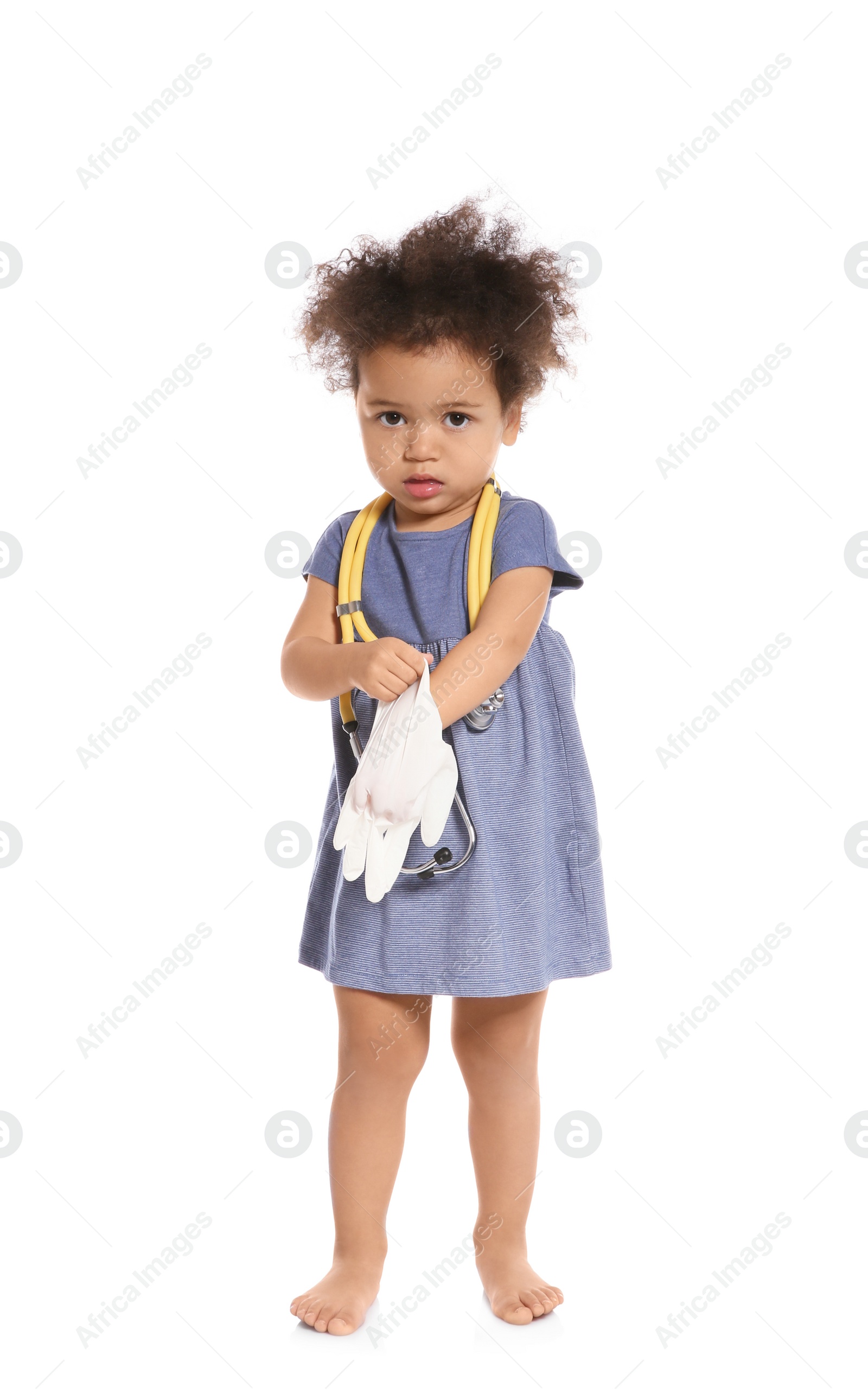 Photo of Cute African American child imagining herself as doctor while wearing rubber glove on white background