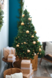 Photo of Blurred view of decorated Christmas tree in living room