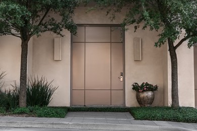 Photo of Closed door of modern building outdoors. Exterior design