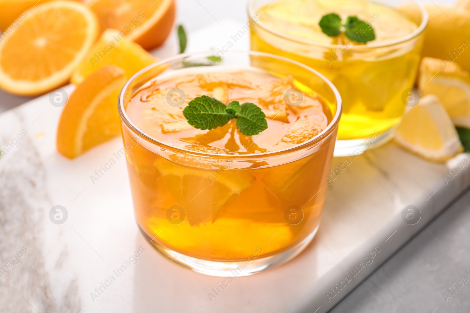 Photo of Glasses of tasty jelly served on light table