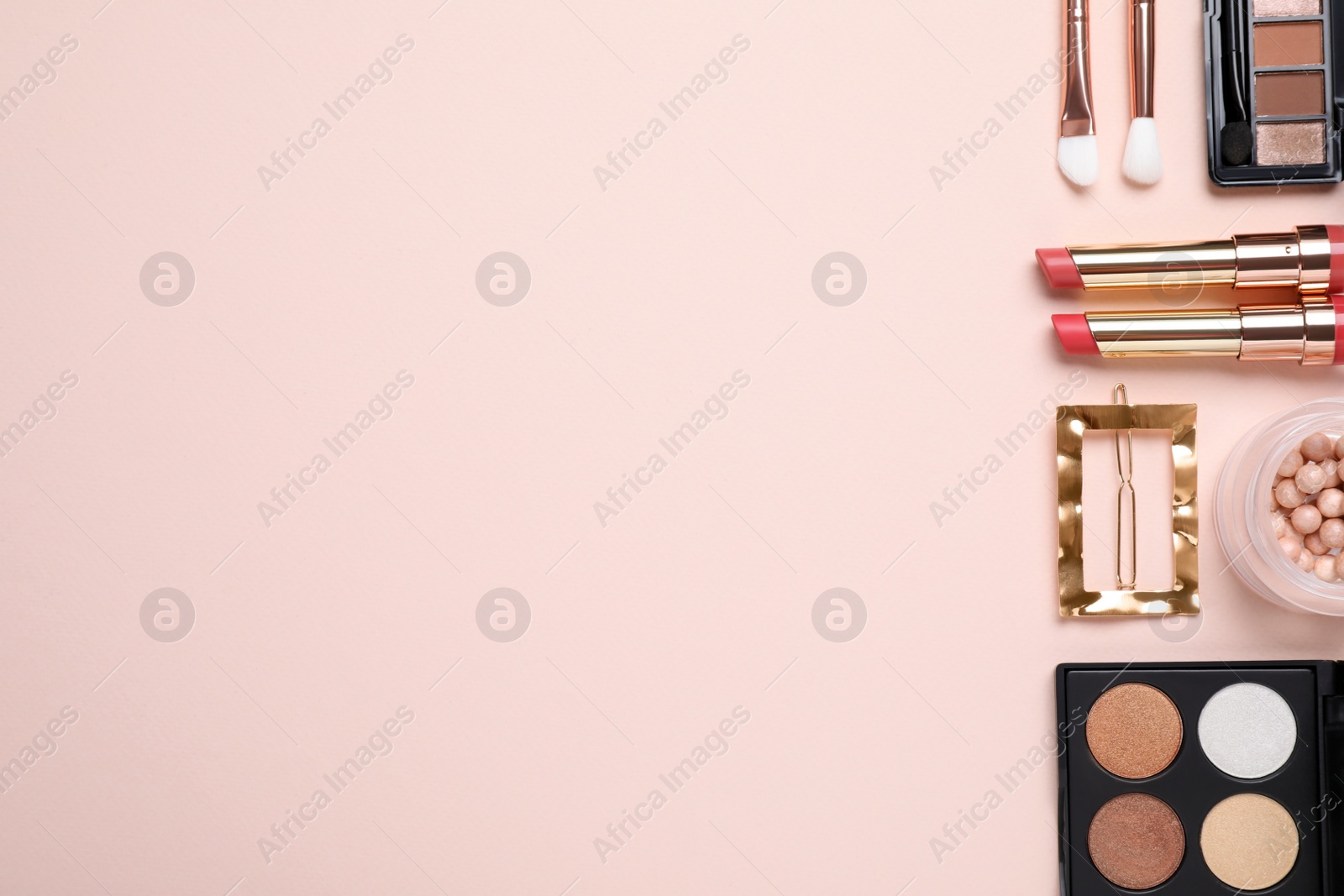 Photo of Flat lay composition with decorative cosmetics on pink background. Space for text